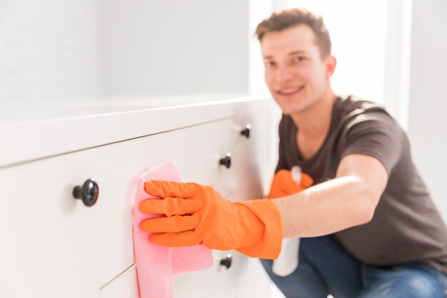 Portrait of man cleaning his house