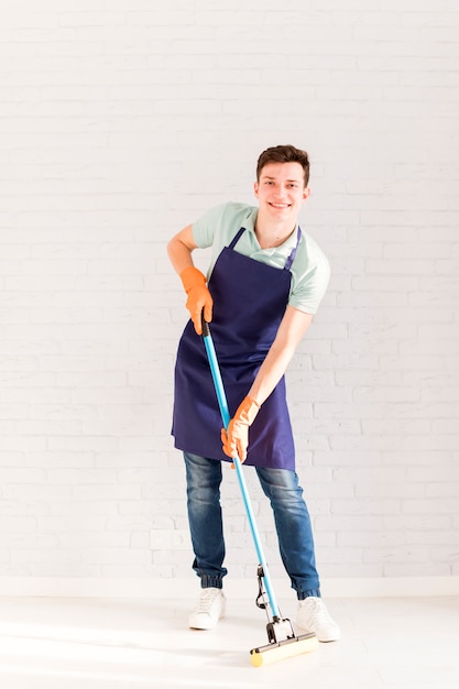 Portrait of man cleaning his house