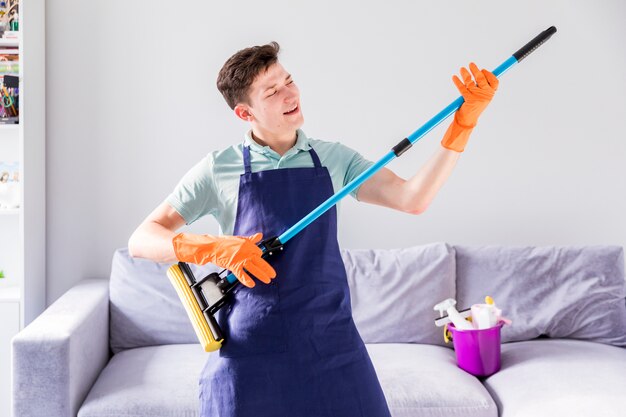 Portrait of man cleaning his house