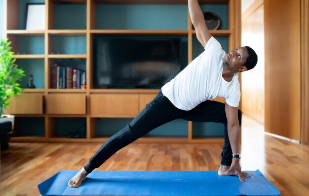 Portrait of a man doing exercise while staying at home. New normal lifestyle concept. Sport concept.