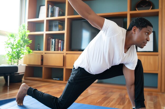 Portrait of a man doing exercise while staying at home