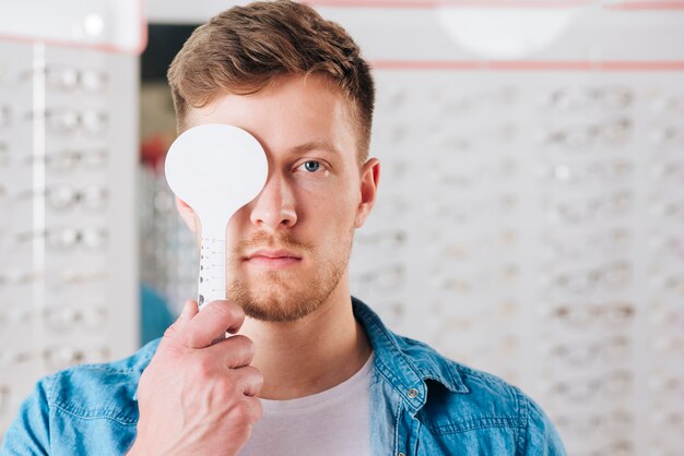 Portrait of man doing test of eye vision