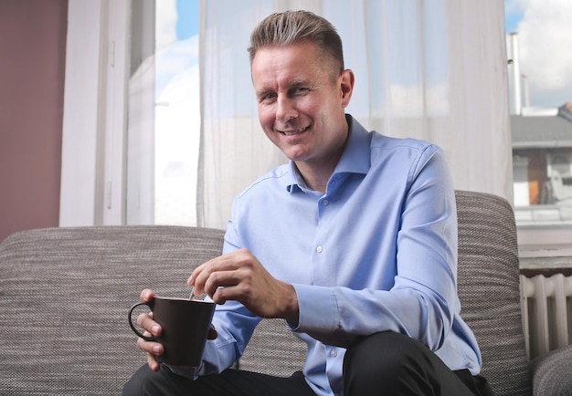 Portrait of man drinking from a cup of tea