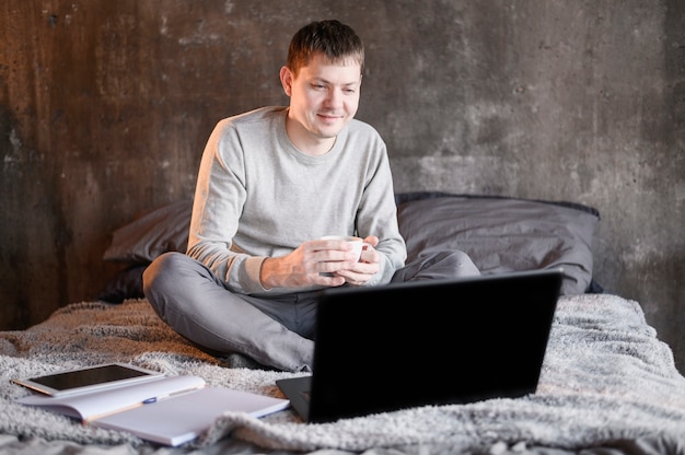 Free photo portrait of man enjoying remote work