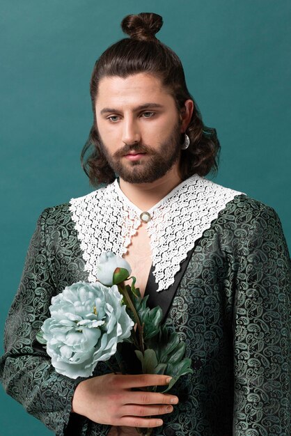 Portrait man in fashionable clothes holding flowers