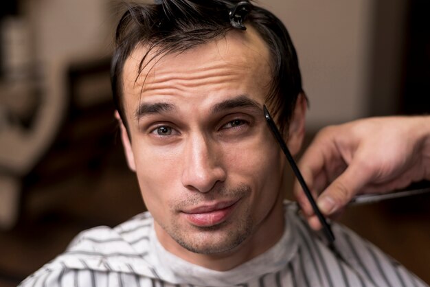 Portrait of a man getting a haircut