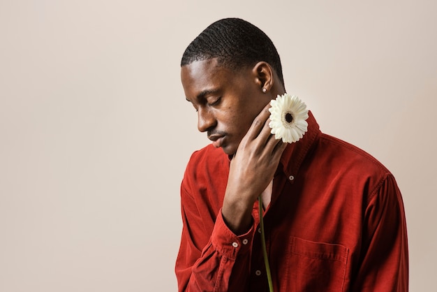 Portrait of man holding flower with copy space