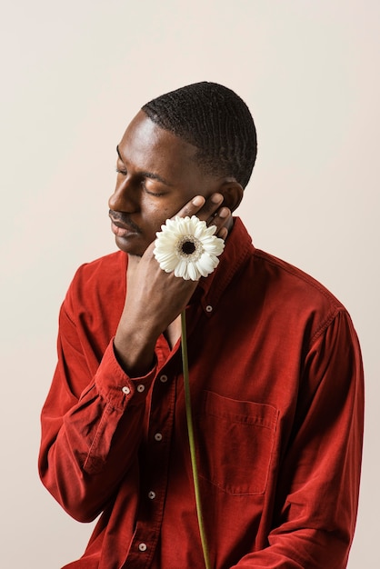 Portrait of man holding flower