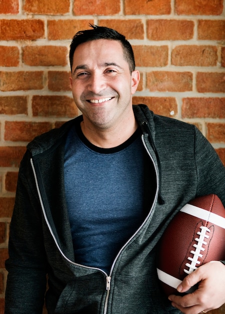 Free photo portrait of man holding rugby ball