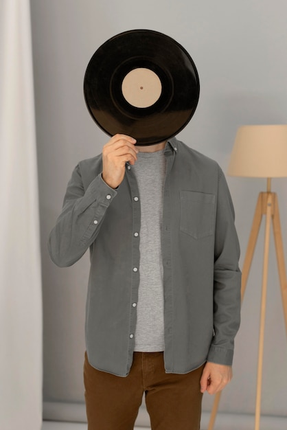 Free photo portrait man holding vinyl