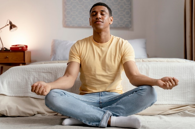 portrait man at home meditating