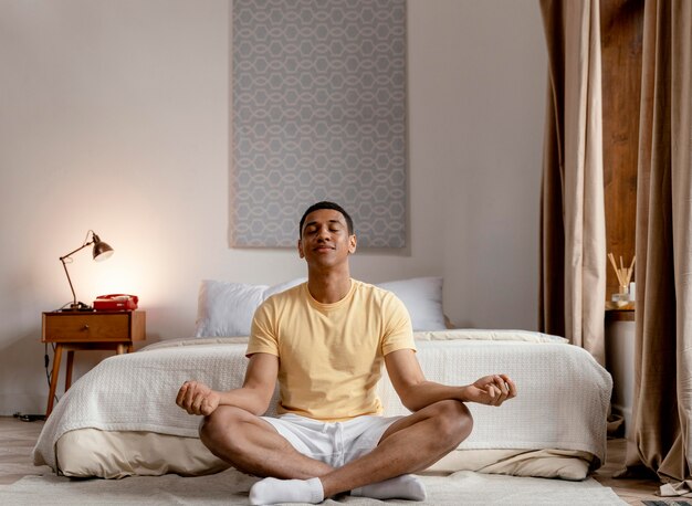 portrait man at home meditating