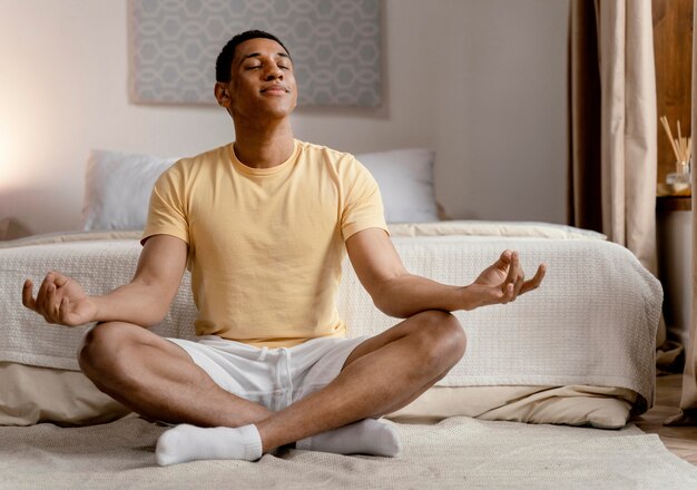 Portrait man at home meditating