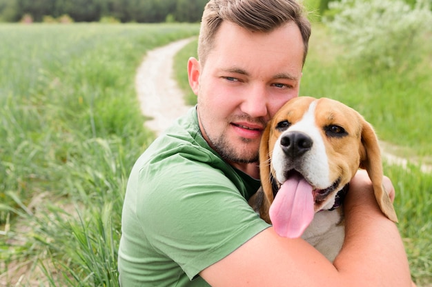 Portrait of man hugging his cute dog