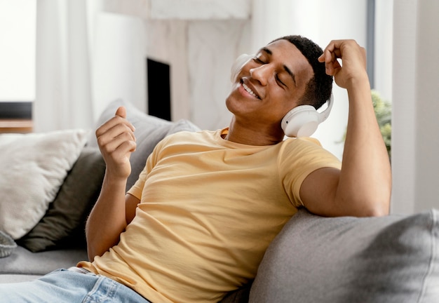 Free photo portrait man relaxing at home while listening music