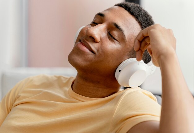 Portrait man relaxing at home while listening music