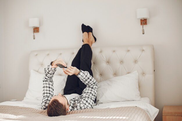 Portrait of man relaxing at home with smartphone