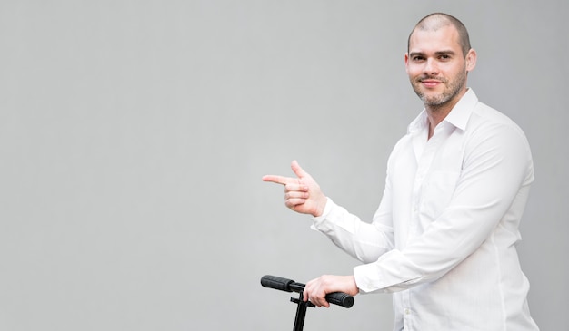 Portrait of man riding scooter with copy space