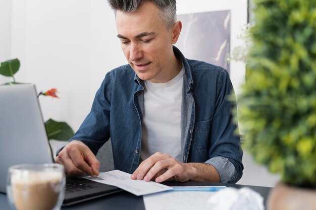 Portrait man sealing envelope