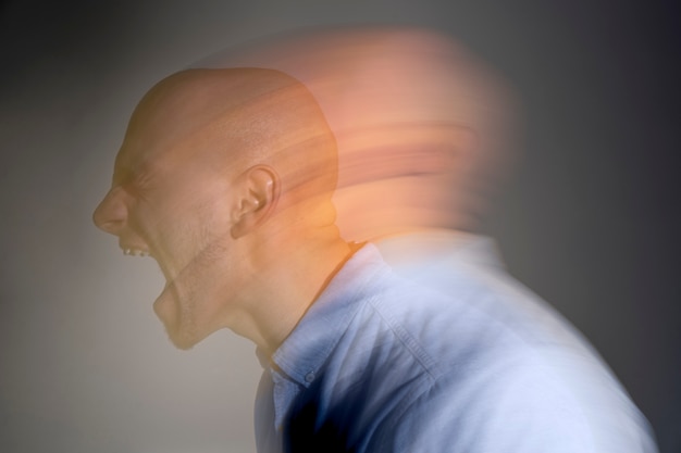 Free photo portrait of man suffering from schizophrenia