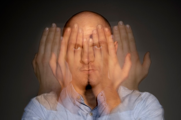 Free photo portrait of man suffering from schizophrenia