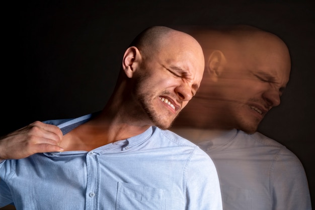 Free photo portrait of man suffering from schizophrenia