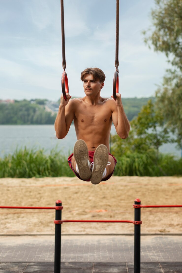 Free Photo portrait of man during summertime in 80's aesthetic working out on rings