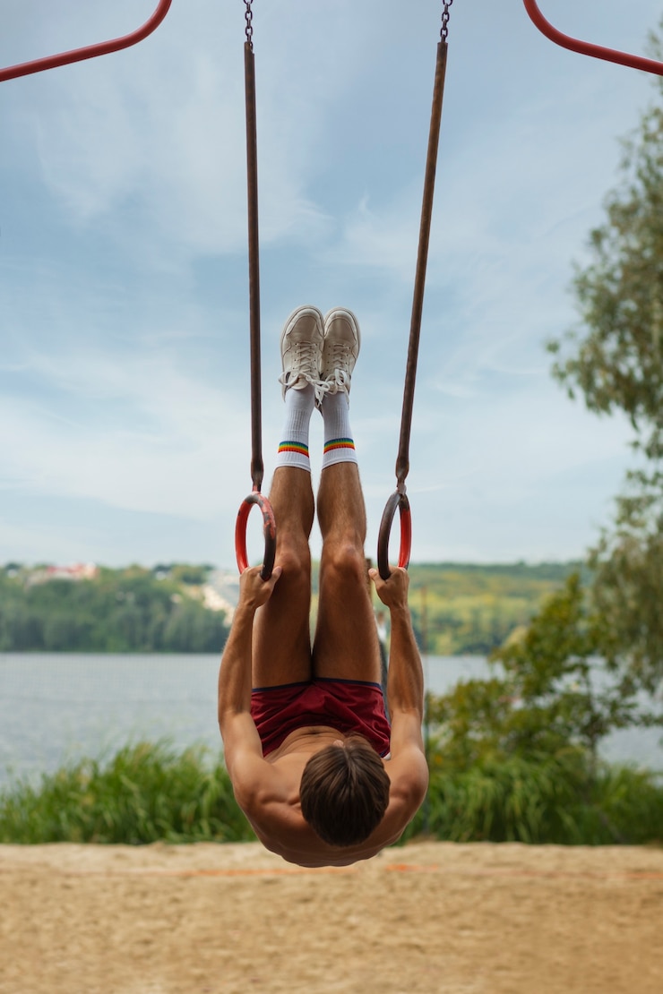 Free Photo portrait of man during summertime in 80's aesthetic working out on rings