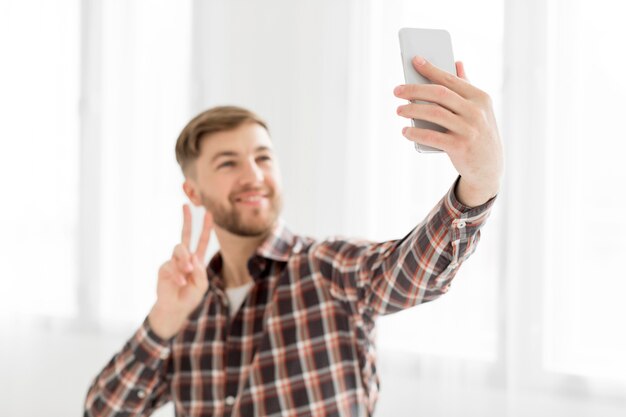 Portrait man taking selfie