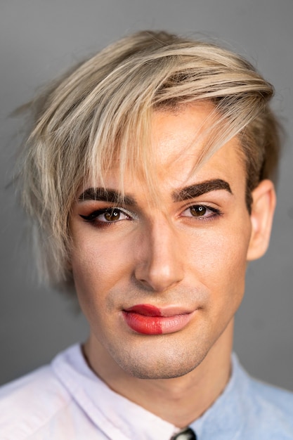 Free photo portrait of man wearing make-up on half his face