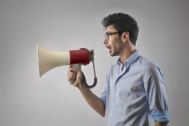 portrait of man while speaking with a megaphone