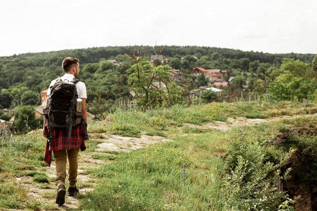 Portrait man with backpack on road