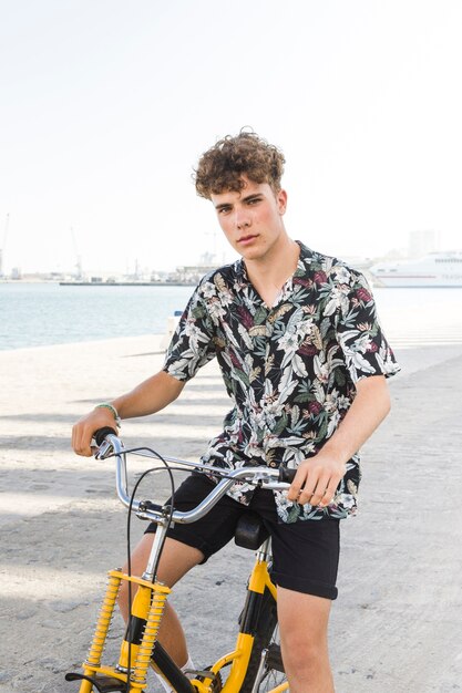 Portrait of a man with bicycle looking at camera