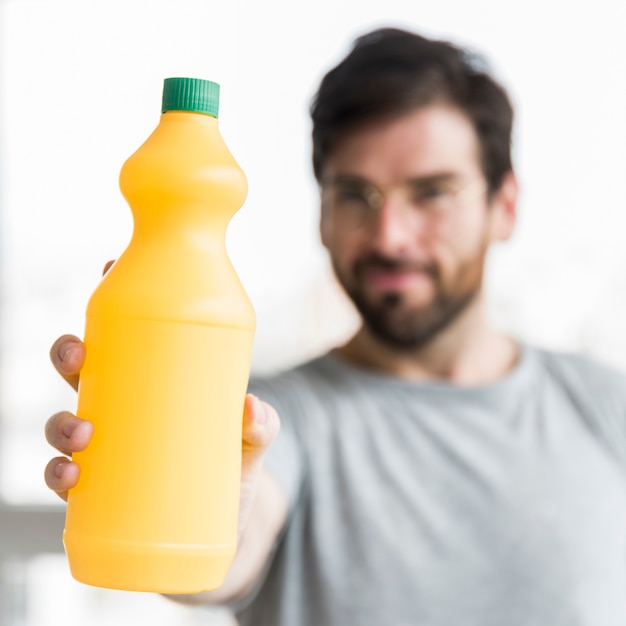 Portrait of man with cleaning product