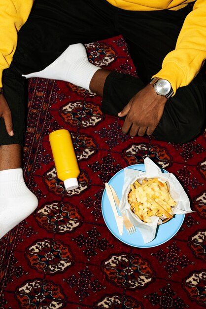 Free photo portrait of man with a dish of poutine