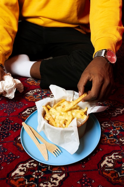 Portrait of man with a dish of poutine