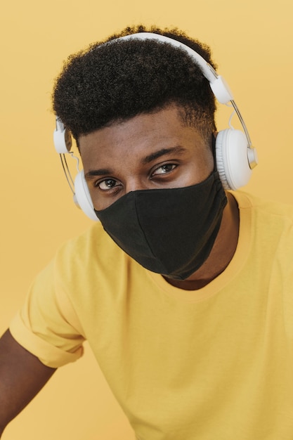 Portrait of man with headphones and face mask