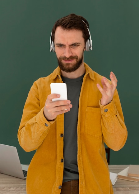 Portrait man with headphones using mobile