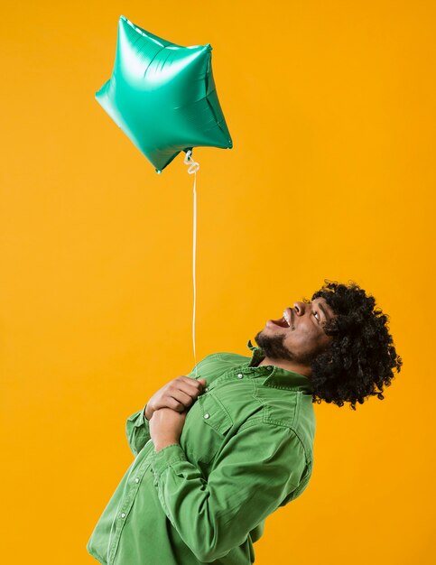 Portrait man with party balloon