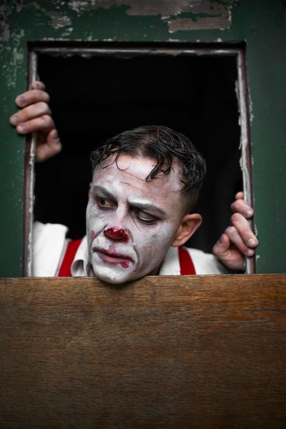 Portrait of man with scary clown make-up