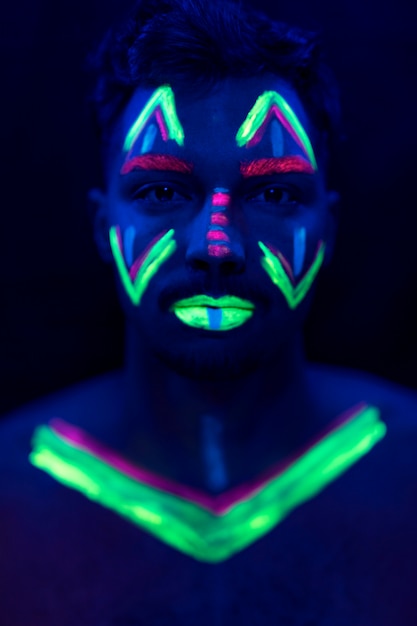 Free photo portrait of man with uv paint