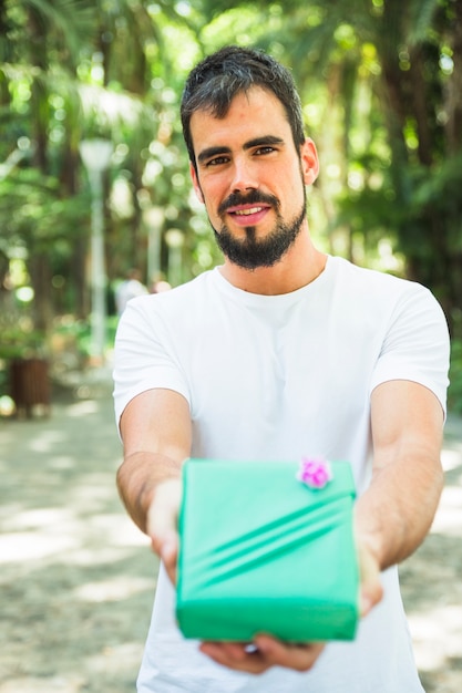 Portrait of a man with valentine gift looking at camera