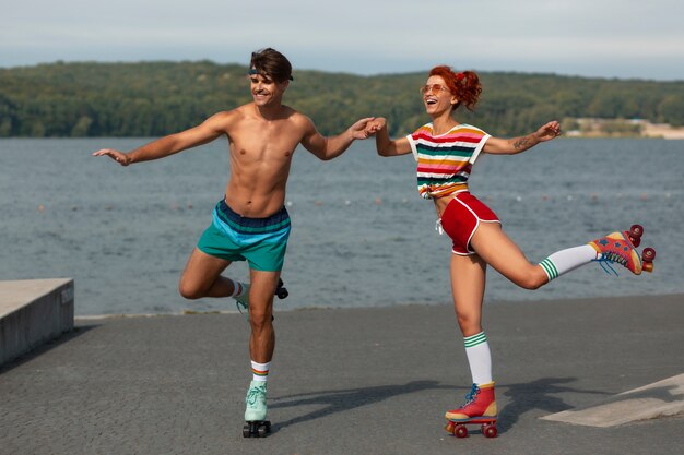 Portrait of man and woman at the beach with roller skates in 80's aesthetic