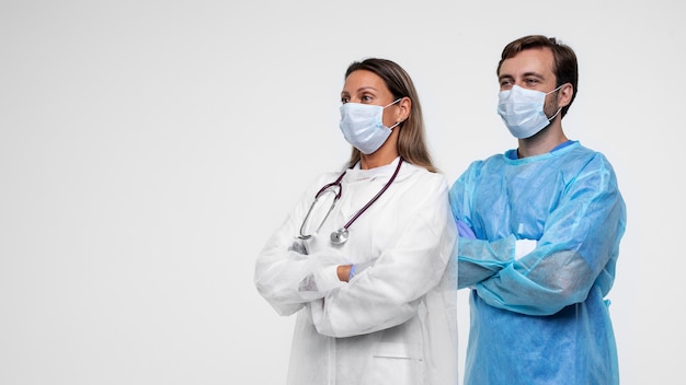 Portrait of man and woman wearing medical gown and medical masks