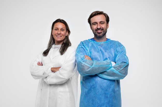 Portrait of man and woman wearing medical gowns