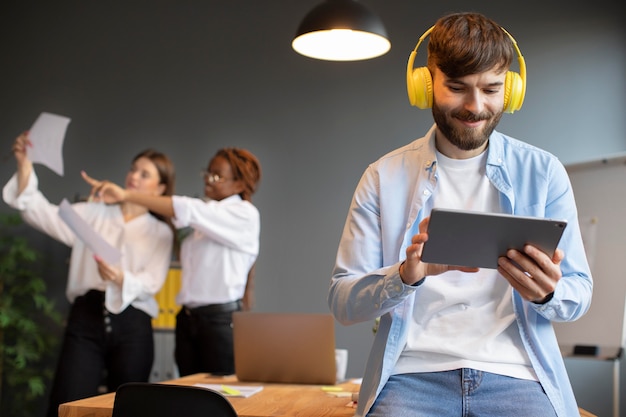 Free photo portrait of man working next to his colleagues