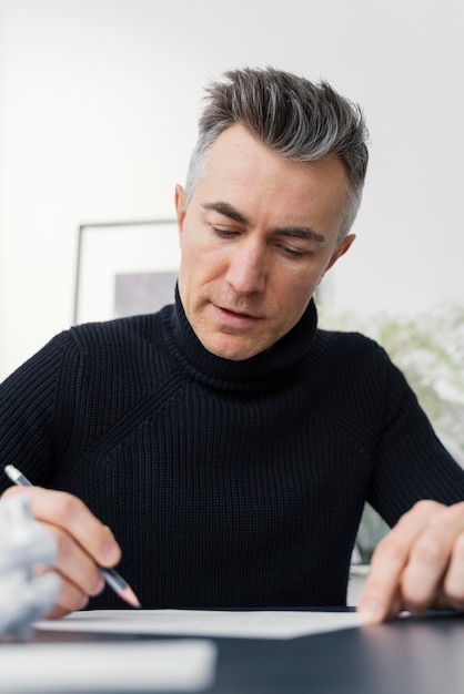 Free photo portrait man writing letter