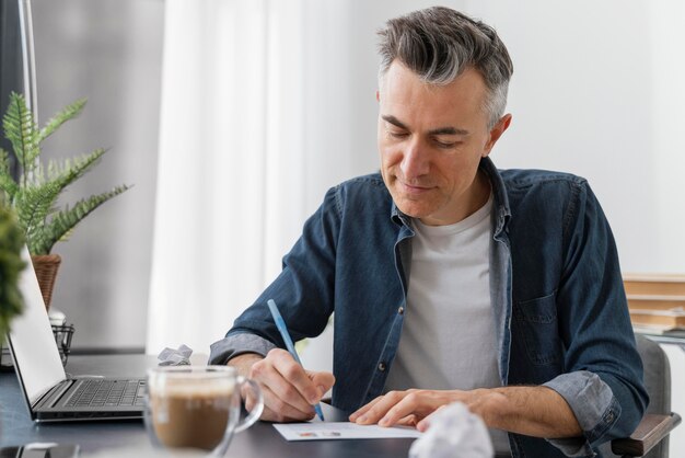 Portrait man writing letter