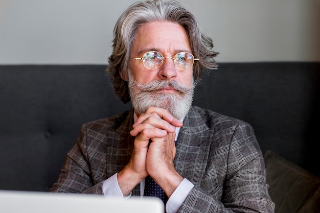 Portrait of mature male with glasses thinking