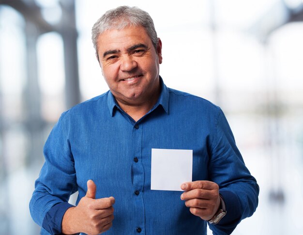portrait of a mature man holding a paper